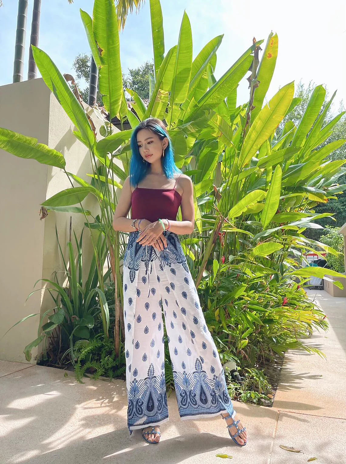 Stylish Boho Wrap Pants in blue and white pattern, paired with a dark red top, perfect for a summer day outdoors.