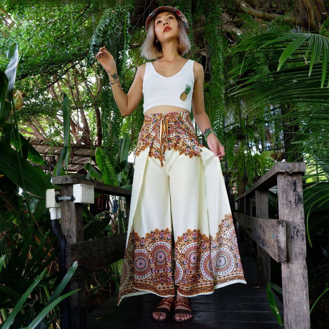 Model in cream boho wrap pants with rich mandala detailing, styled for tropical vibes.