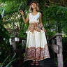 Model in cream boho wrap pants with rich mandala detailing, styled for tropical vibes.