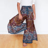 Muted blue mandala wrap pants mid-motion, capturing the flow of boho festival fashion.