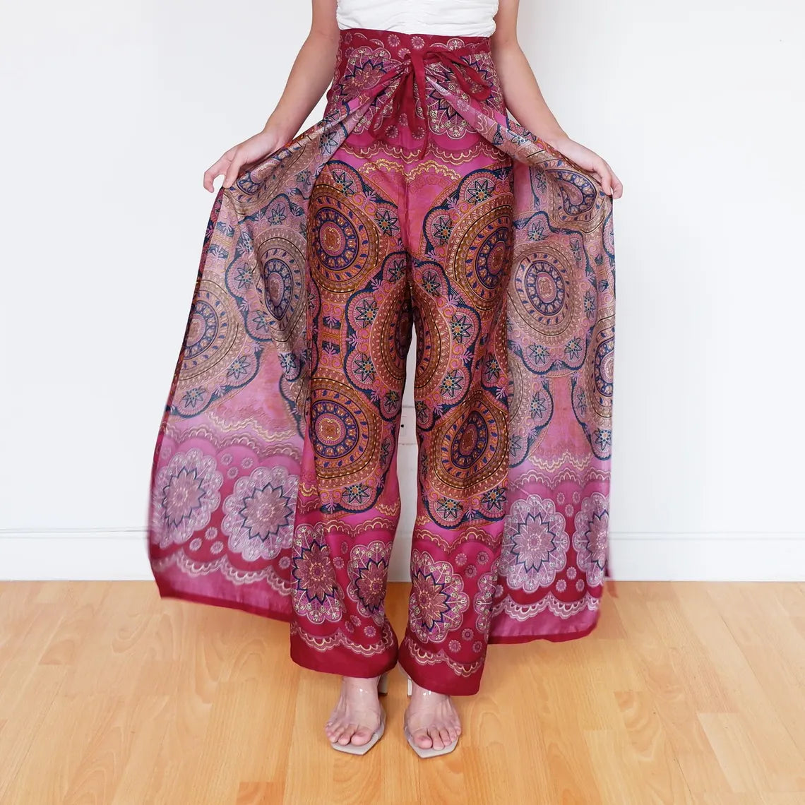 Wide-leg sunset pink mandala wrap pants fanned out for a bold boho statement.