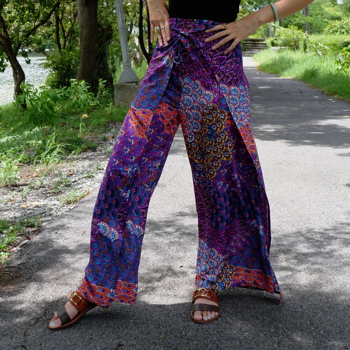Chic boho wrap pants with a vibrant purple petals print, ideal for a fashionable and eclectic look.