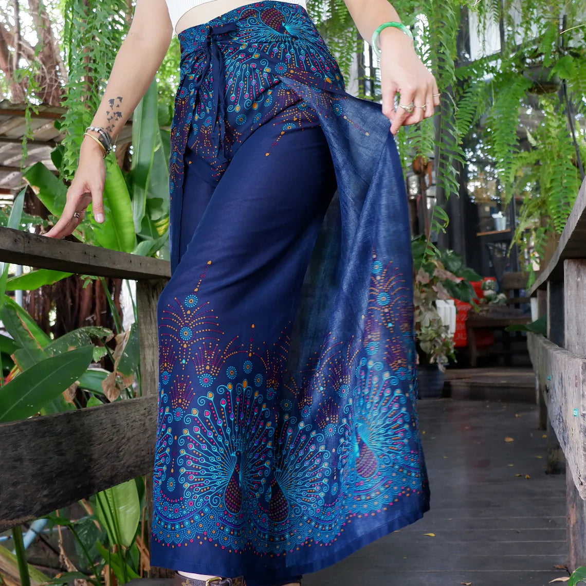 Chic Navy Blue Boho Peacock Print Wrap Pants in Lush Outdoor Ambiance