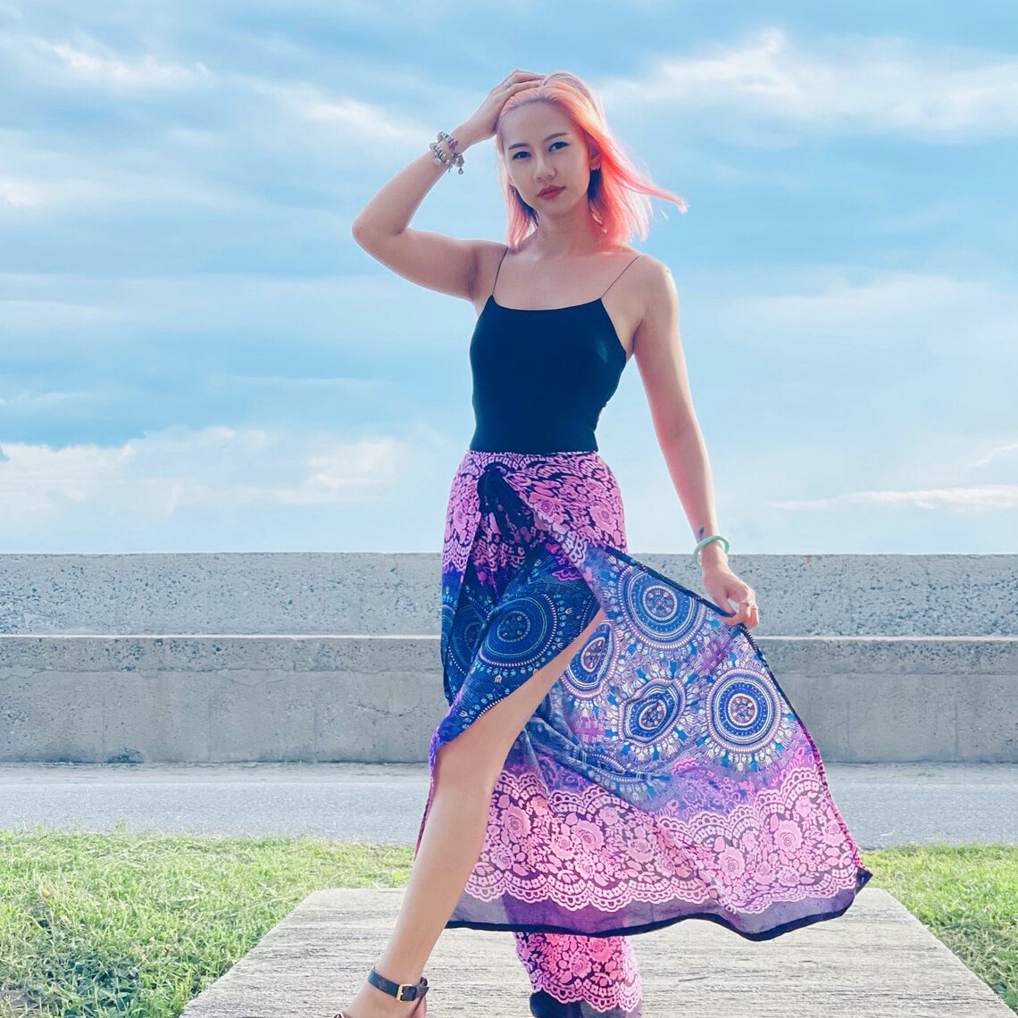 Model posing in purple mandala wrap pants with slit open, perfect for beach or festival wear
