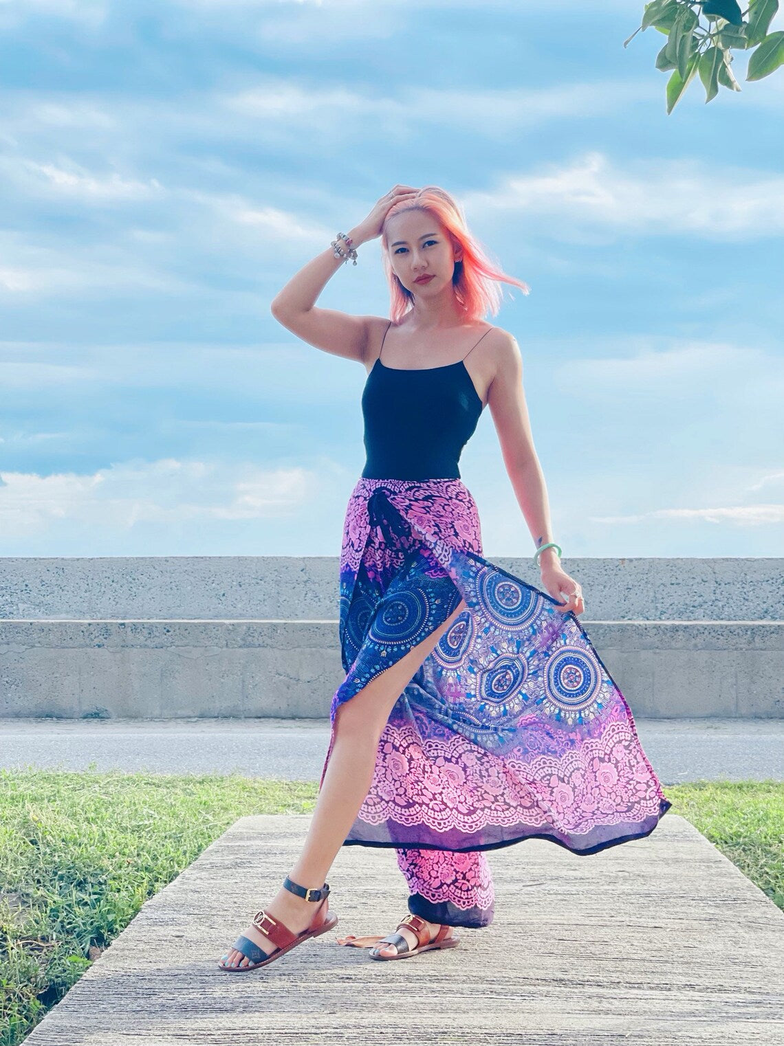 Model posing in purple mandala wrap pants with slit open, perfect for beach or festival wear

