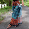 Flowy wrap pants with teal mandala print and floral border, opened leg showing wrap style
