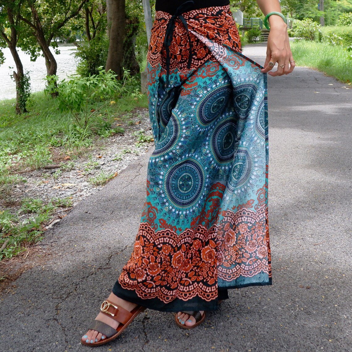 Flowy wrap pants with teal mandala print and floral border, opened leg showing wrap style
