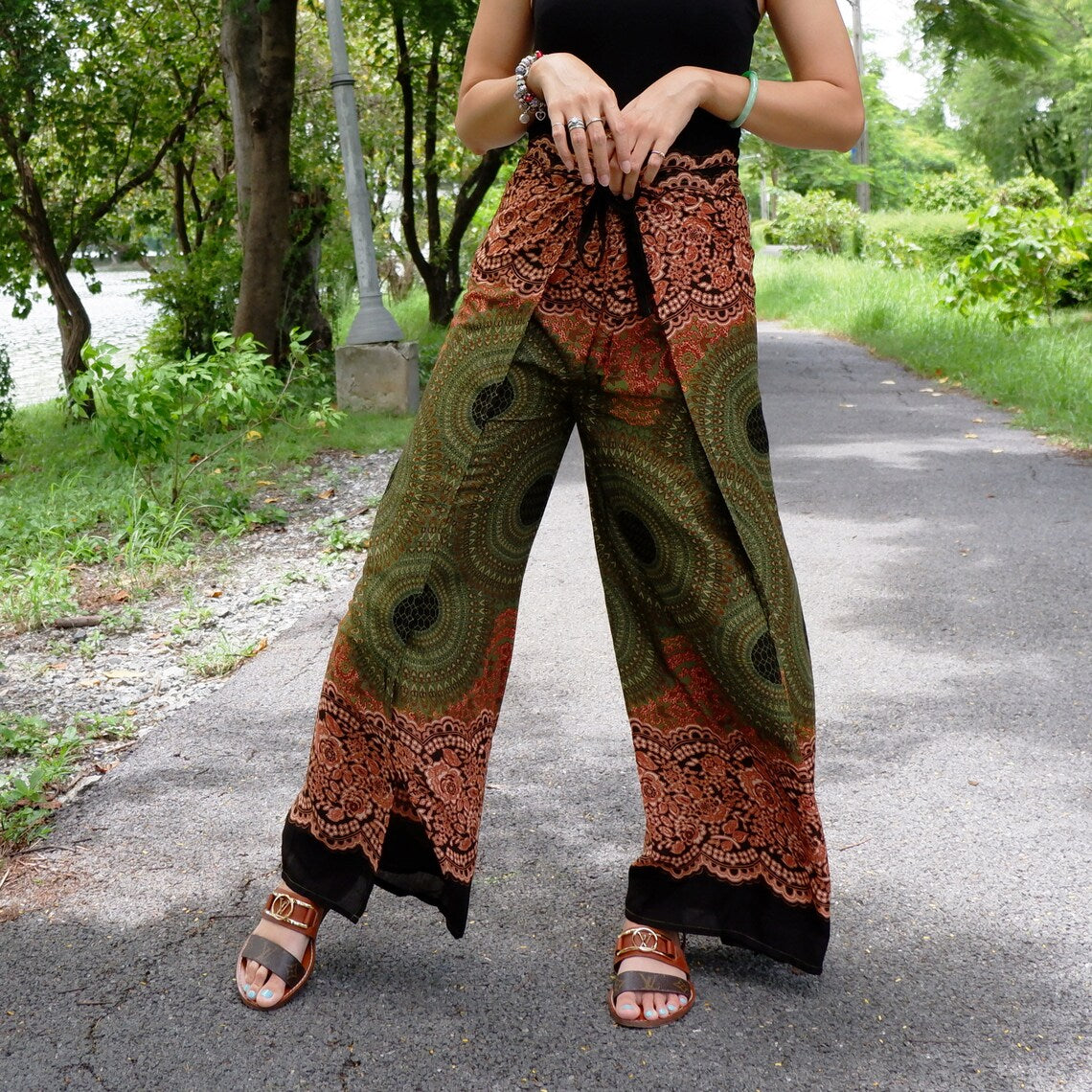 Boho beach wrap pants with intricate green, orange, and black patterns, perfect for outdoor summer fashion.