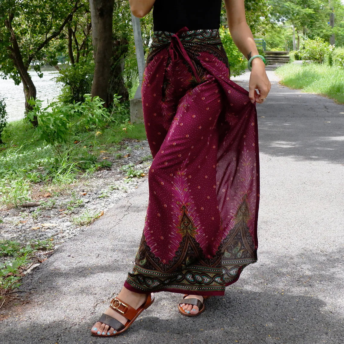 Fashionable red maroon boho feather print wrap pants paired with a chic black top, perfect for outdoor style.