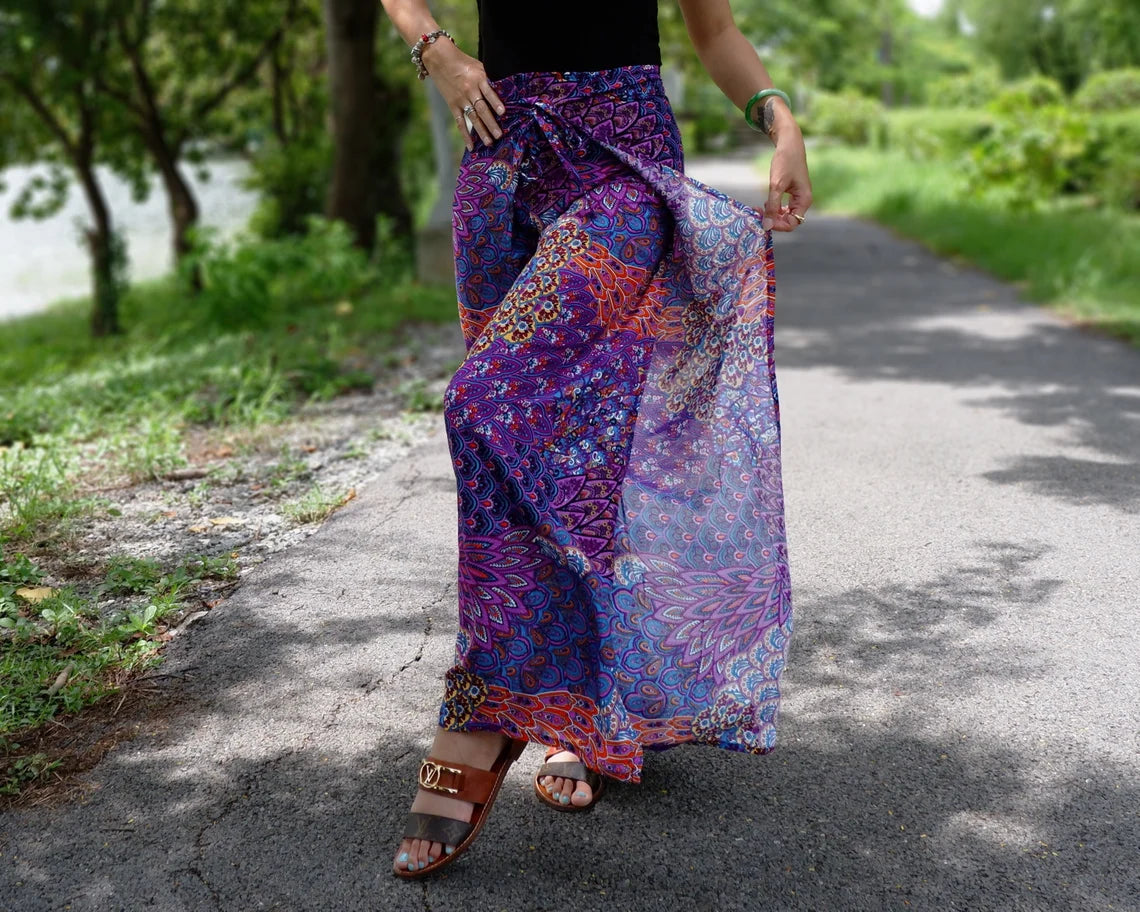 Stylish boho wrap pants with a lush purple petals print, perfect for a trendy and artistic look.