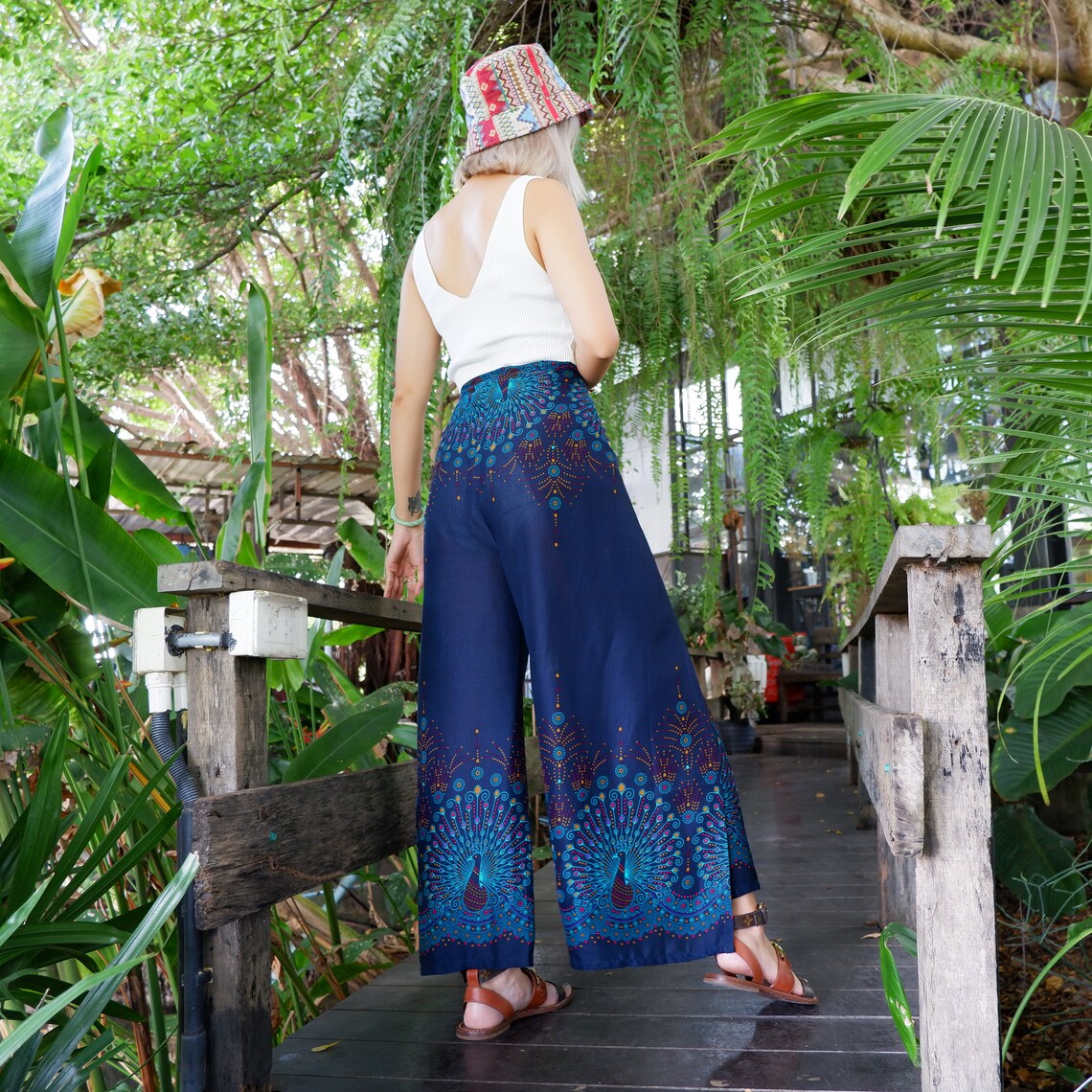 Stylish navy blue boho peacock print wrap pants paired with a chic white top, ideal for a fashionable outdoor look.