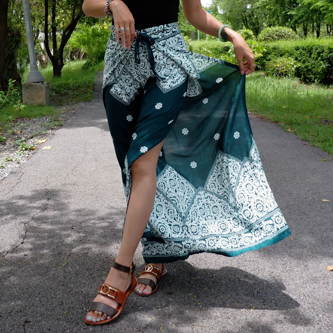 Teal Boho Wrap Pants with Intricate Floral Print on Model Outdoors.