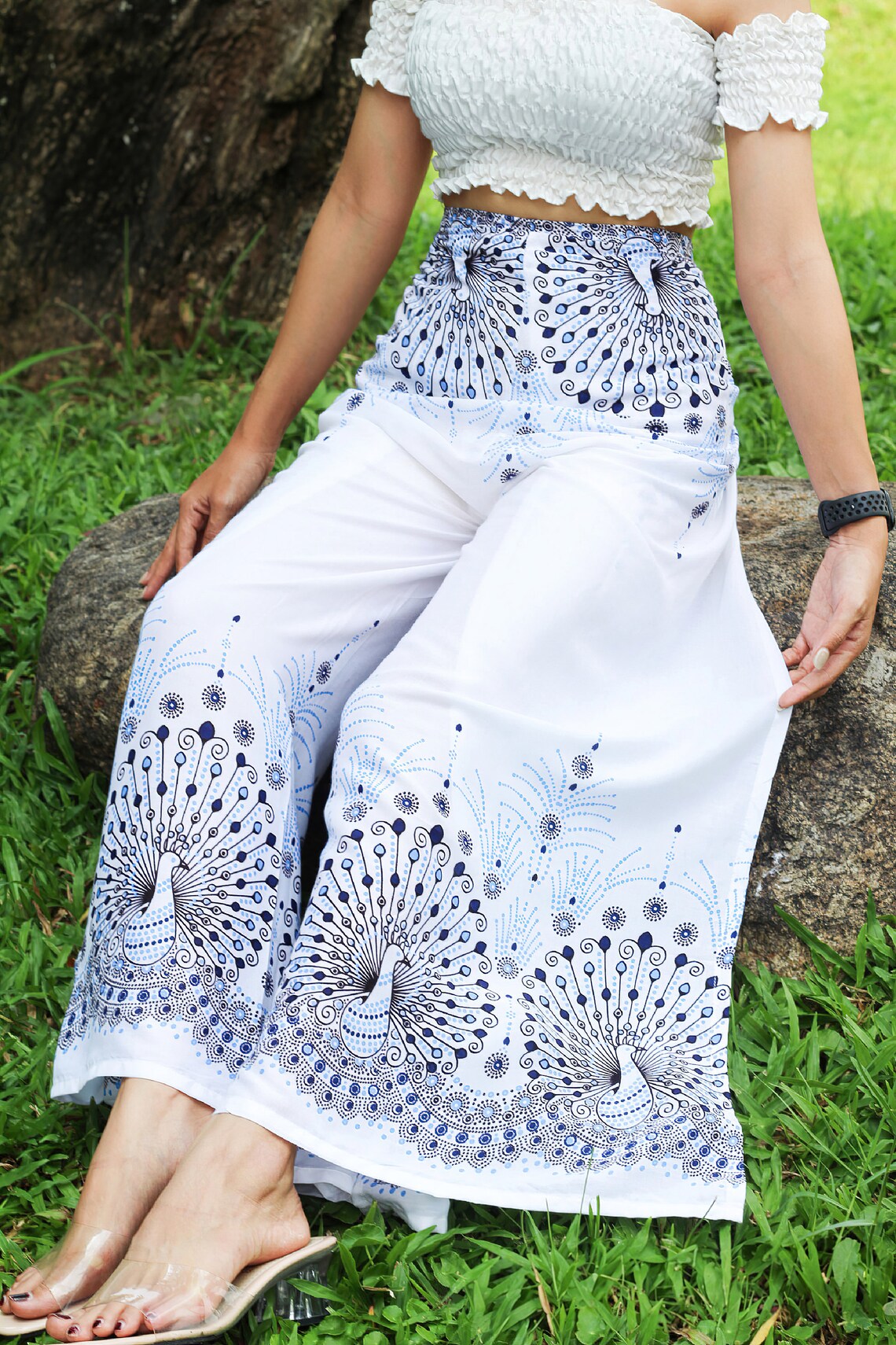 Trendsetting white boho wrap pants adorned with blue peacock print, perfect for a serene yet stylish look.